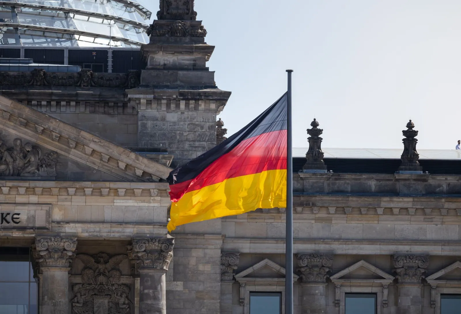 German flag flying in front of the Reichstag building in Berlin
