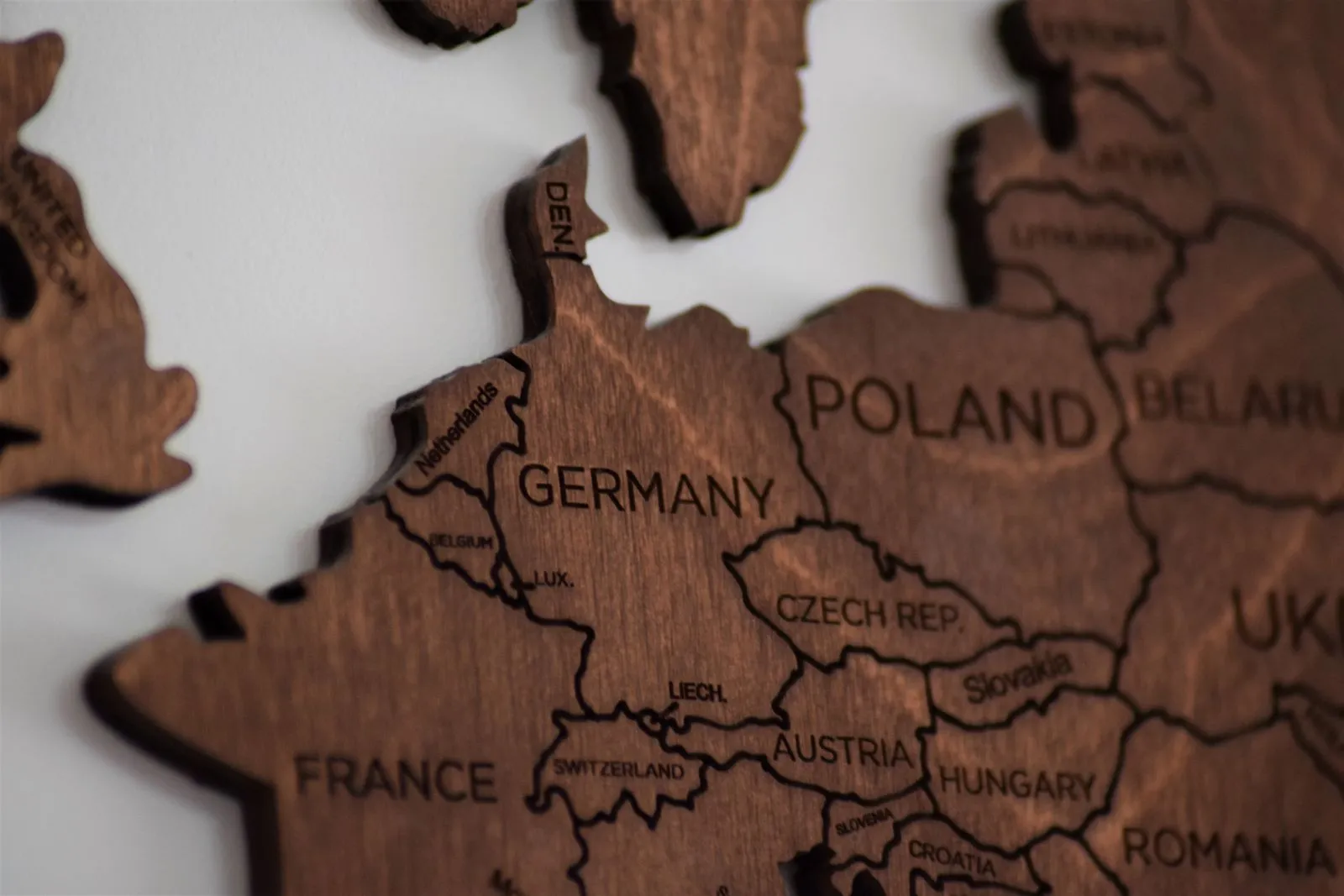 Close-up of a wooden wall map of Europe showing Germany, France, the Netherlands, Poland and neighbouring countries